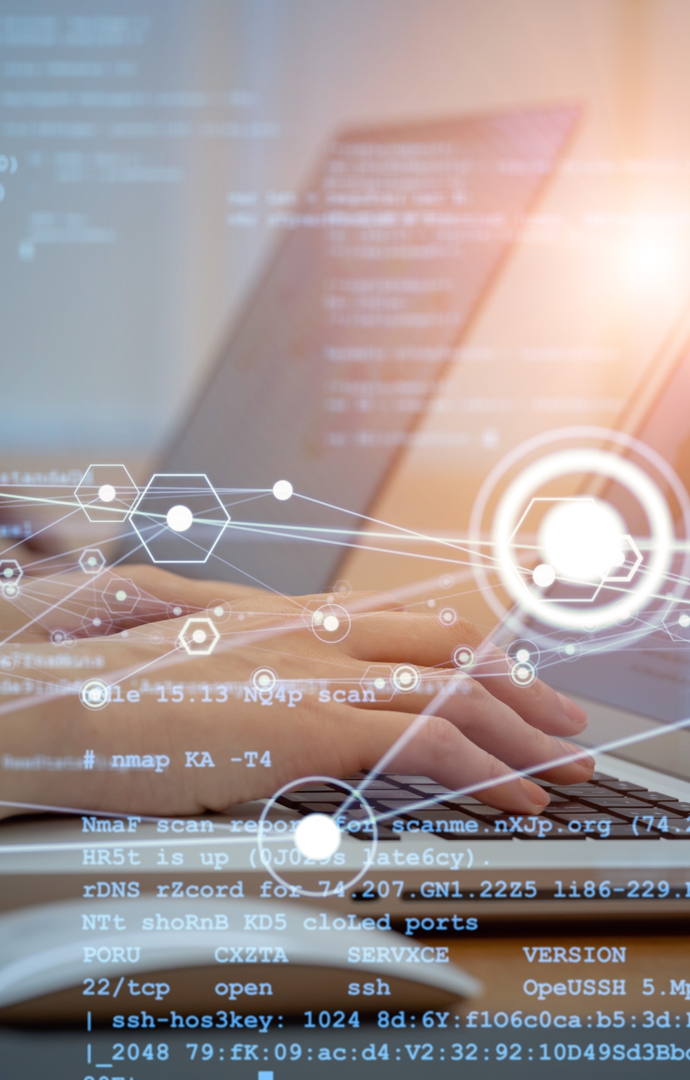 hands typing on a laptop showing charts and statistics