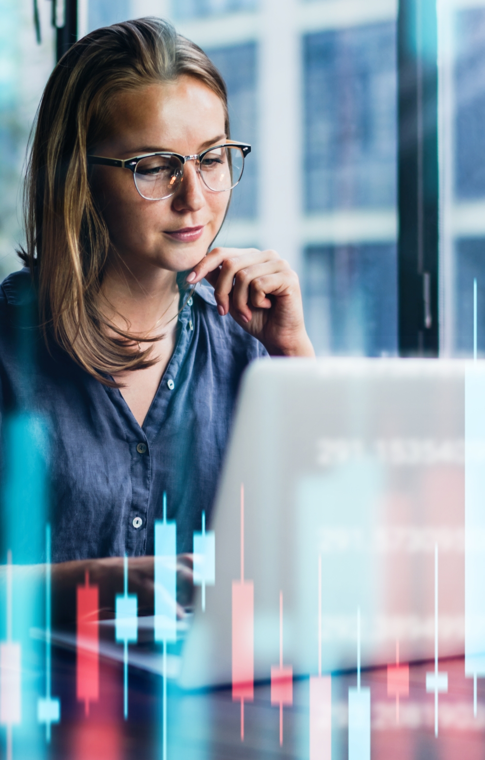 picture of lady looking at computer screens and colorful virtual charts