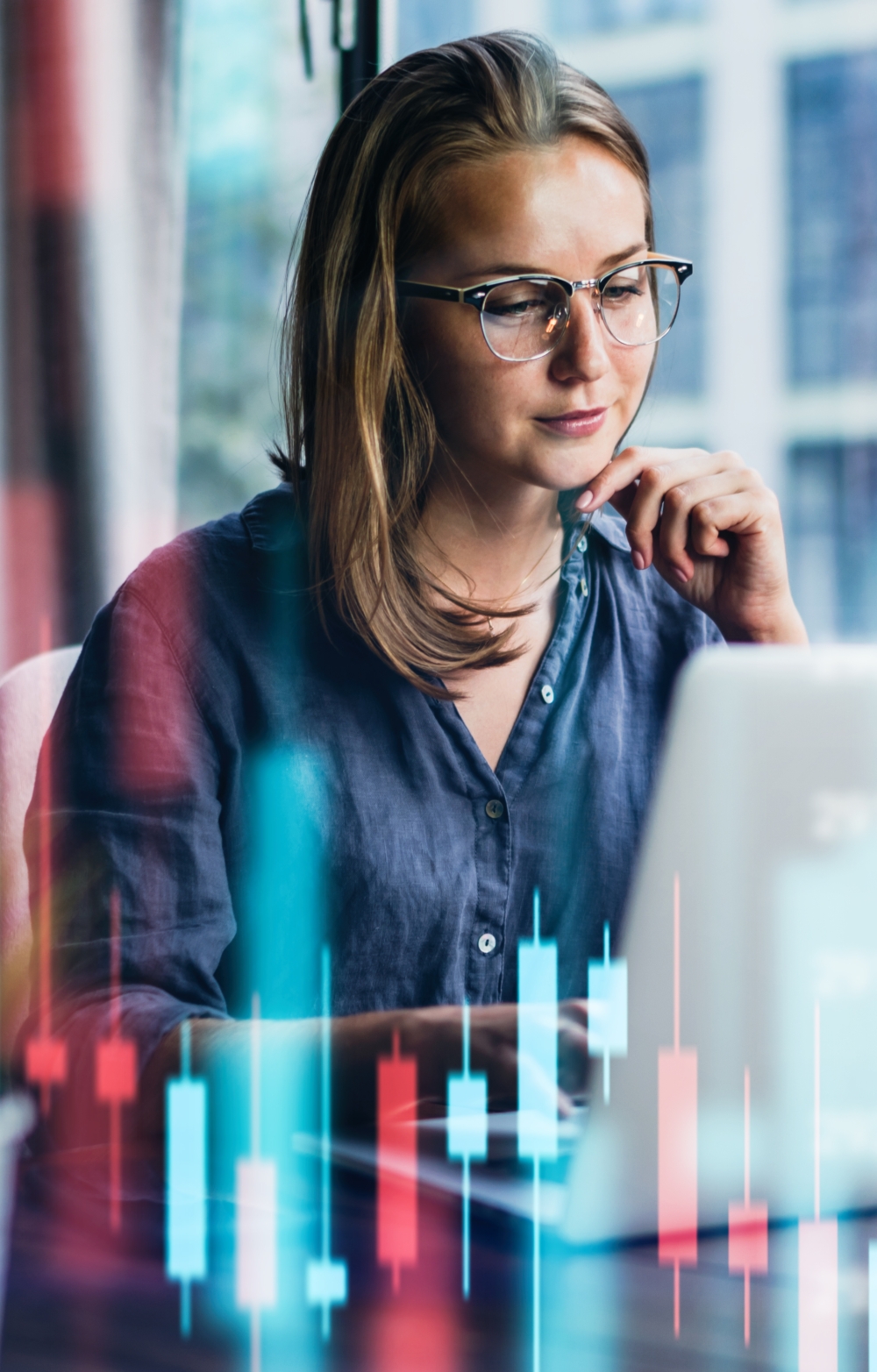 Lady looking at a laptop screen surrounded by virtual bar charts in different colours