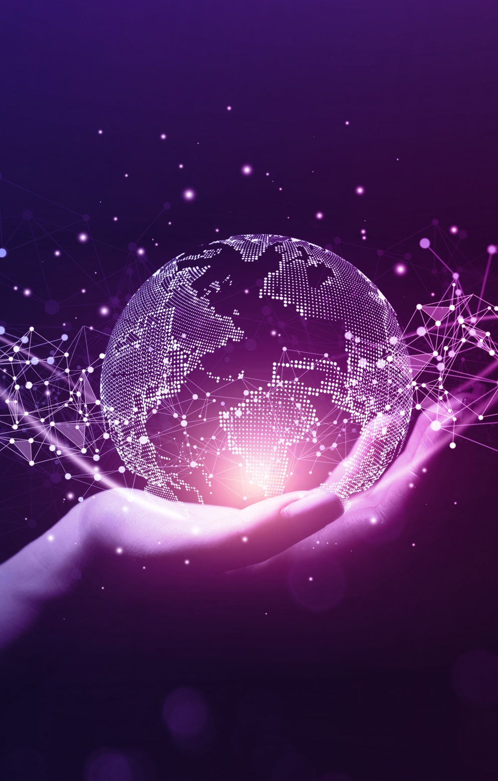 Hand holding a crystal ball of the world in purple and dark blue hues