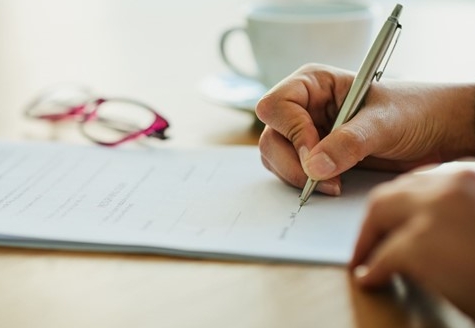 sustainability reporting paper and hand