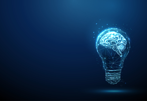 Brightly-lit light bulb against a dark background